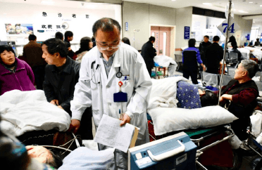 Doctor examines patients in a corridor at Zhongshan Hospital, Shanghai